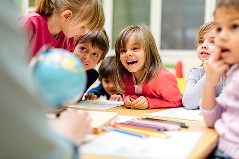 Kinder vor einem Globus